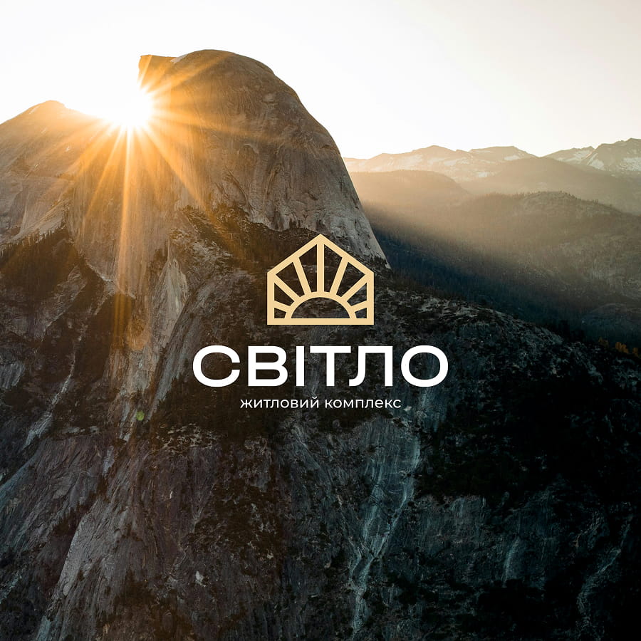 Brand logo for the Svito residential complex over a sunlit mountain background with a sunburst icon.